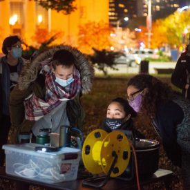 Mina Aria (in the middle), setting up the projector